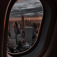 an airplane window looking out at the city