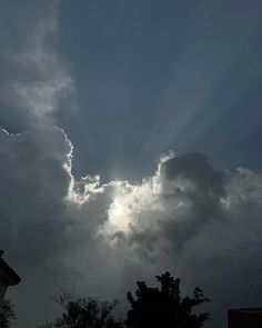 the sun is shining through some dark clouds