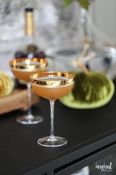 two martini glasses sitting on top of a counter