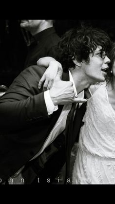 a bride and groom kissing in front of their guests