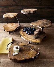 three pieces of wood sitting on top of a table next to cheese and crackers