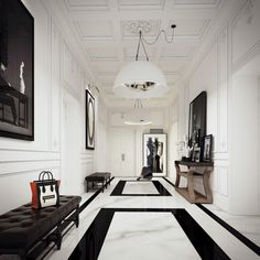 a long hallway with black and white flooring, framed pictures on the walls and an upholstered bench