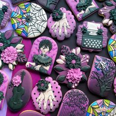 decorated cookies are arranged on top of each other in purple and green colors, with an image of a woman holding a typewriter