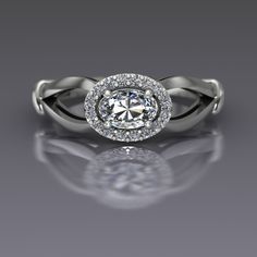 "An oval cut diamond is sideways set and surrounded by a halo of diamonds in this 14k white gold ring. Diamond is the April birthstone and has been given as an engagement ring for centuries. This petite east-west set ring measures about 7mm at the widest point. Oval Diamond Dimensions6x4mm (approx.) Carat Weight .37(approx.) EnhancementNatural ColorF-G ClaritySI1 CutVery Good PolishVery Good Diamonds Number16 EnhancementNatural Carat Total Weight0.12 ColorG-H ClaritySI2-I1 CutVery Good PolishVer Oval Diamond Ring With Accents In 14k White Gold, Diamond White Oval Halo Ring With Brilliant Cut, Oval Brilliant Cut Diamond White Halo Ring, Oval Halo Ring In Diamond White, Oval Diamond White Halo Ring, Oval Halo Ring With Diamond Accents In Platinum, Oval Halo Ring In Platinum With Diamond Accents, White Oval Halo Ring With Rose Cut Diamonds, Oval Platinum Halo Ring With Diamond Accents