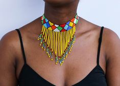 African beaded necklaces, African beaded jewelry, Beaded women jewelry, Christmas gift for her, Moms gift, Fringe necklace, Gift for her An elegant necklace that can match any outfit. Handmade by the Maasai women in Kenya using fine beads. Color: Yellow Available in different colors.  Neck size: 14 inches 3-5 days delivery via DHL Express.  Pay shipping fee for the first item only and additional items ship for free. To view more items in our shop, kindly click here:  nkoroicrafts.etsy.com Multicolor Beaded Choker For Celebration, Adjustable Beaded Fringe Necklace, Traditional Beaded Fringe Necklace As Gift, Adjustable Beaded Fringe Jewelry Gift, Adjustable Beaded Necklaces For Celebration, Adjustable Beaded Fringe Jewelry As Gift, Yellow Beaded Necklace Gift, Adjustable Beaded Necklaces With Beaded Fringe As Gift, Yellow Necklaces With Dangling Beads As Gift