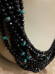 "A gorgeous nine strand faceted black onyx 4mm necklace with natural turquoise flat scattered beads 6mm by 3mm. This beautiful stunning showcase piece measures 22\" inside strand and outside strand measuring 23\". A comfortable wear for that special occasion." Elegant Turquoise Jewelry With Black Beads, Black Multi-strand Necklace With Faceted Beads, Elegant Faceted Turquoise Beaded Necklace, Elegant Adjustable Turquoise Necklace With Faceted Beads, Elegant Multi-strand Turquoise Gemstone Necklace, Seed Bead Necklace Ideas, Bead Necklace Ideas, Crackle Quartz, Creative Necklace