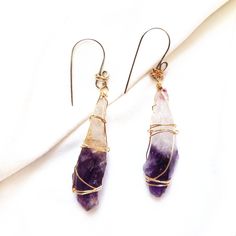 Raw Amethyst earrings Do you want to carry the gift from the earth with you? Raw quartz earrings, they are one of a kind and only one in the world! Each raw crystals form in a variety of different sizes and shapes. They might look alike but nothing is the same. That makes these raw gemstone jewelry so unique and special. These raw Amethyst is gently wire wrapped with 14K gold filled wire, and suspending on the hand crafted silver ear hooks. This is a very unique and modern design necklace of mix Mystical Drop Earrings As Gift, Spiritual Wire Wrapped Earrings For Gift, Handmade Mystical Earrings For Gift, Unique Amethyst Jewelry With Matching Earrings, Handmade Amethyst Drop Earrings, Handmade Mystical Crystal Earrings As Gift, Unique Amethyst Teardrop Earrings, Unique Amethyst Earrings With Natural Stones, Unique Amethyst Purple Earrings