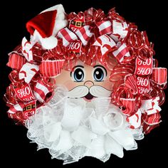 a santa claus wreath made out of lollipops