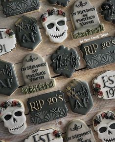 decorated sugar cookies with names and date displayed on wooden table for celebration or halloween party