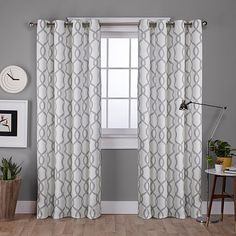 a living room with grey walls and white curtains