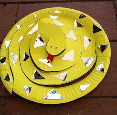 a yellow paper plate with a face on it