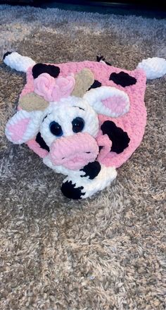 a stuffed cow is laying on the floor