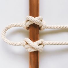 a close up of a wooden pole with ropes on it