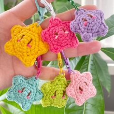 small crocheted animal keychains are hanging from a string in the palm of a person's hand