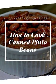 a white bowl filled with baked beans on top of a table