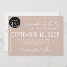 save the date card with a black circle on it