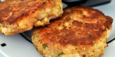 two crab cakes sitting on top of a white plate