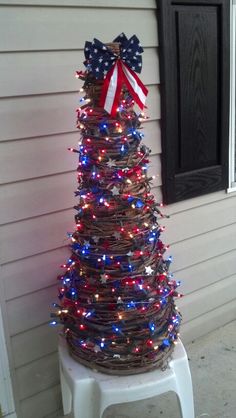 a patriotic christmas tree is decorated with red, white and blue lights