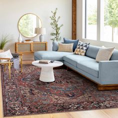 a living room filled with furniture and a large rug