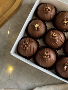 a white box filled with chocolates on top of a table