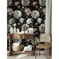 a room with a table, chair and flower wallpaper on the wall in front of it