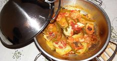 a pan filled with food sitting on top of a stove