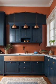 a kitchen with blue cabinets and copper accents on the walls, along with an area rug