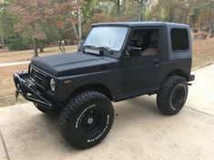 a black jeep parked on top of a sidewalk