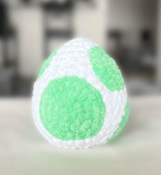 a green and white ball sitting on top of a table