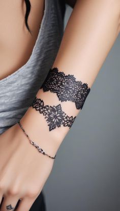 a woman's arm with a black lace bracelet on it