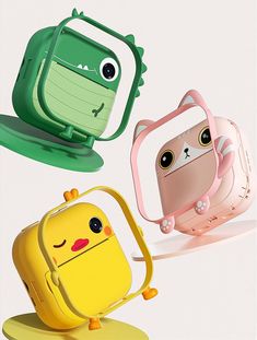 three cute little backpacks sitting on top of each other with faces drawn on them