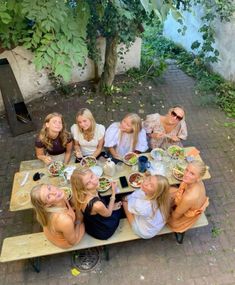 a group of women sitting at a picnic table