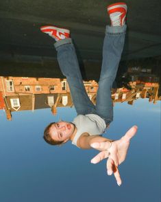 a man flying through the air while riding on top of a skateboard with his feet in the air