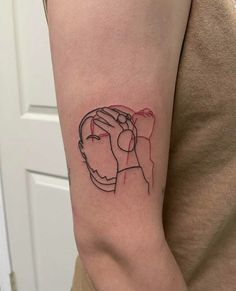 a woman's arm with a tattoo on it that has a drawing of two hands holding each other