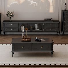 a living room scene with focus on the coffee table and entertainment center in the background