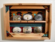 Rustic / Western Décor Hanging Wall Art Belt Buckle display. This display will hold six belt buckles of your choice. Here is the perfect item to display your beautiful belt buckles that you have collected or earned. Made from cedar wood and a beautiful Southwest background material and corners are also accented with the same Southwest material attached with copper upholstery tacks and for added eye appeal we have added western tacks to the center rail also. Each piece is personally signed, dated Western Belt Buckle Display, Trophy Buckle Display, Buckle Holder Diy, Belt Buckle Holder, Buckle Display Ideas, Southwestern Furniture