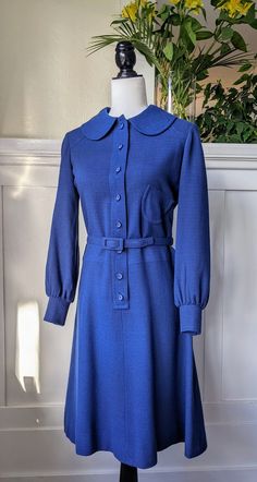 Rare original 70's vintage Miss Dior, by Christian Dior, wool or rayon crepe dress in navy blue, labeled size 9. Fully lined with royal blue satin liner. Featuring peter pan collar, button down closure at the front, original belt, bra holders inside, off center top left pocket, slightly puffed sleeves at cuffs and buttoned cuffs. In excellent vintage condition with no visible flaws. Best fits size S/M. Measurements taken laying flat in inches: Shoulder to shoulder 1/6 Armpit to armpit 18 Waist 1 70s Satin Dress, Vintage Wool Dress For Workwear, 1970s Style Fall Workwear Dresses, Miss Dior Dress, Katherine Graham, Vintage Dior Dress, Bra Holder, Christian Dior Dress, Dior Dress