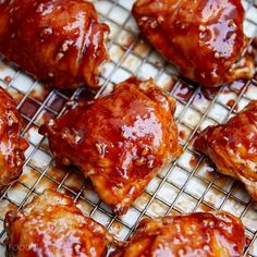 several pieces of meat covered in bbq sauce on a cooling rack