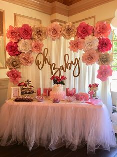 a baby shower table with pink and white flowers