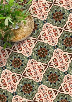 a potted plant sitting on top of a wooden table next to a floor tile