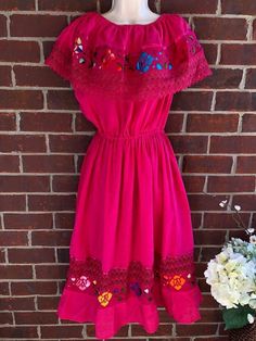 Fits S,M,l & xl Hand embroidery. color flowers may vary a little bit on each dress **Includes matching Embroidered belt which may vary on color too(one the matches your dress) I recommend Wash by hand. All items are ship the same day if you buy them before 3pm Monday-Friday. Ready to ship! Thank you for supporting my small shop. Pink Vintage Dress With Floral Embroidery, Vintage Pink Dress With Floral Embroidery, Red Vintage Dress With Floral Embroidery, Pink Floral Embroidered Festival Dress, Pink Floral Embroidered Dress For Festival, Pink Bohemian Dress For Fiesta, Pink Fitted Dress For Fiesta, Pink Embroidered Dress For Spring Festival, Mexican Fiesta Dresses