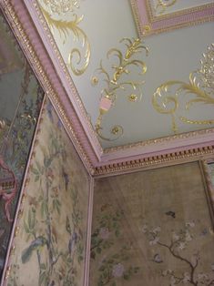 the ceiling is decorated with gold and pink designs on it's walls, along with other wallpapers