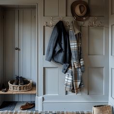 a coat rack with hats and shoes hanging from it's hooks on the wall