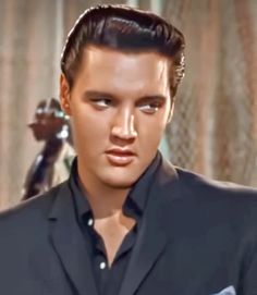 elvis presley wearing a black suit and tie