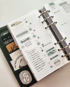 an open planner book sitting on top of a table