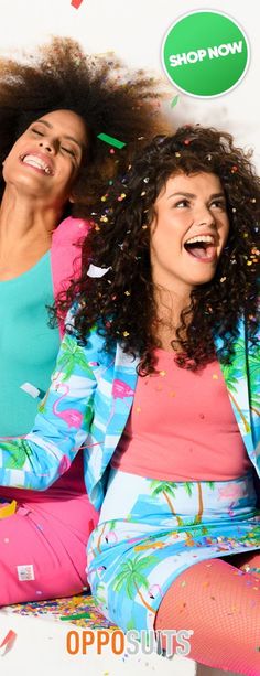 two women sitting on the floor with confetti all over them