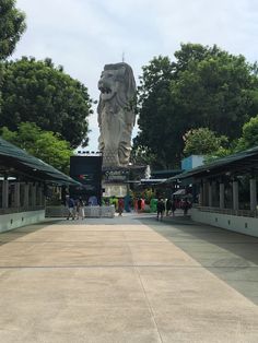 a large statue is in the middle of a walkway