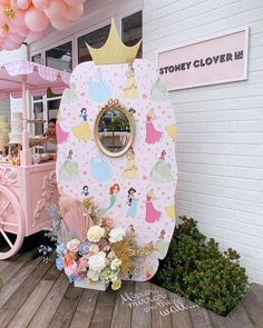 there is a pink and gold costume on display at the fairground with balloons in the background