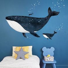 a child's bedroom with a whale wall decal