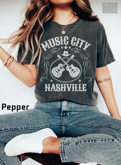 "PRODUCTION TIME: 1-3 days (Usually 2 days) SHIPPING TIME: 2-5 days (Usually 3 days) 👕PRODUCT DESCRIPTION👕  Step into the heart of country music with our \"Nashville Music City\" t-shirt. This vintage-inspired tee is the perfect addition to any music lover's wardrobe. Featuring a classic guitar design and a retro Music City logo, this shirt is made from comfortable and durable garment-dyed material. Whether you're exploring the city or attending a concert, this tee is sure to become your go-to Music-themed Screen Print Top For Concerts, Cotton Tops For Music Festivals And Concerts, Cotton Tops For Music Festival Concerts, Music-themed Short Sleeve Tops For Music Festivals, Music-themed Tops For Concerts And Music Festivals, Music-themed Tops For Concerts And Festivals, Music-themed Screen Print Tops For Music Festivals, Pre-shrunk Shirt For Music Festivals, Rock And Roll Letter Print T-shirt For Music Festival